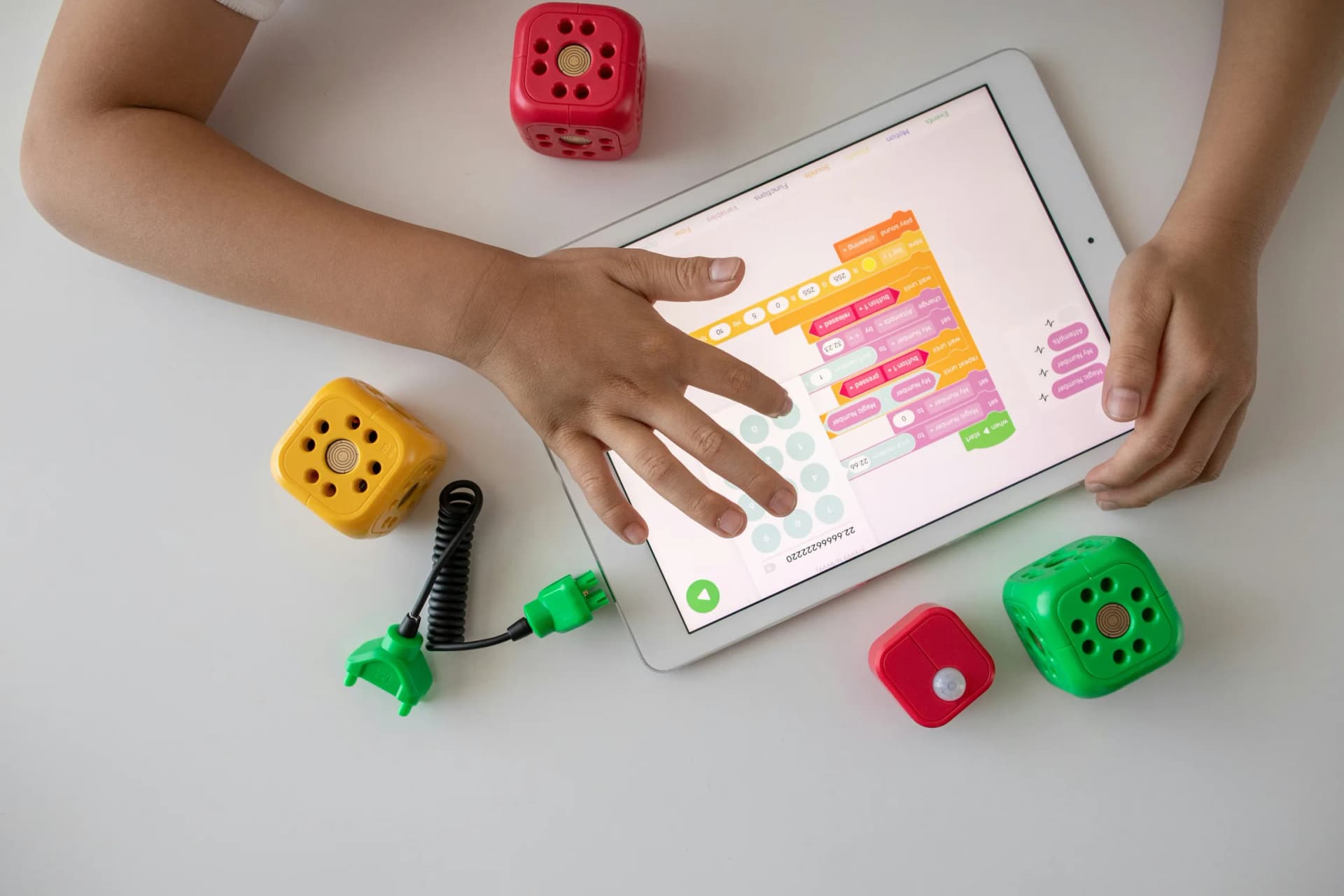 Student learning on a tablet with hands-on activities